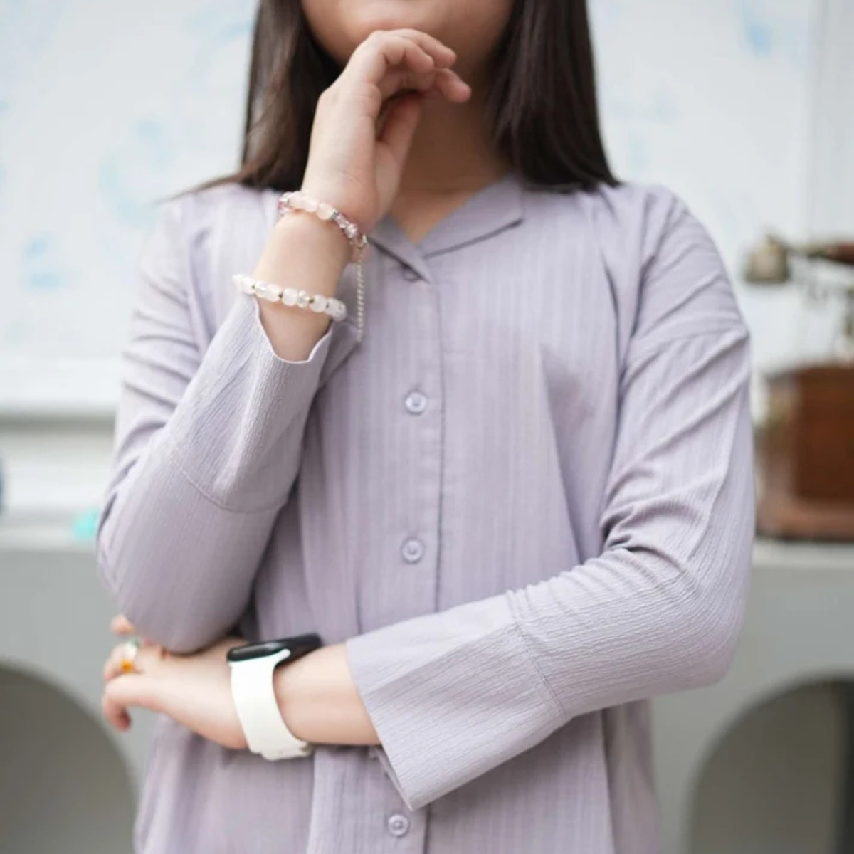 Front detail of the grey co-ord shirt showing collar, buttons and sleeve cuffs