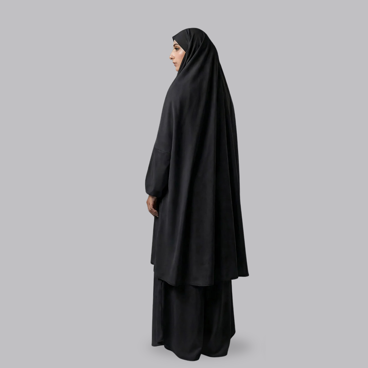 Side view of the black two-piece jilbab showing the long draped top and skirt
