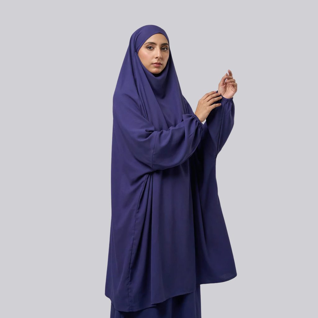 Front view of a woman wearing the navy blue jilbab and draped head covering