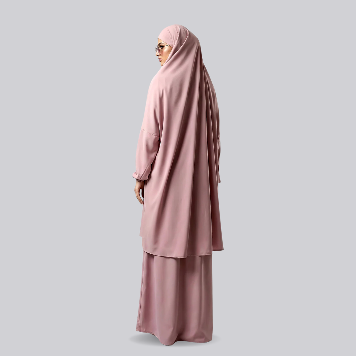 Side view of the light pink two-piece jilbab with its draped top and full-length skirt