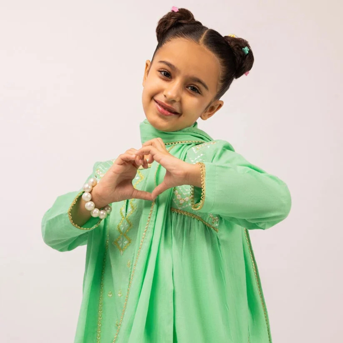 Girls’ green dobby outfit with embroidery and contrasting decorative edging