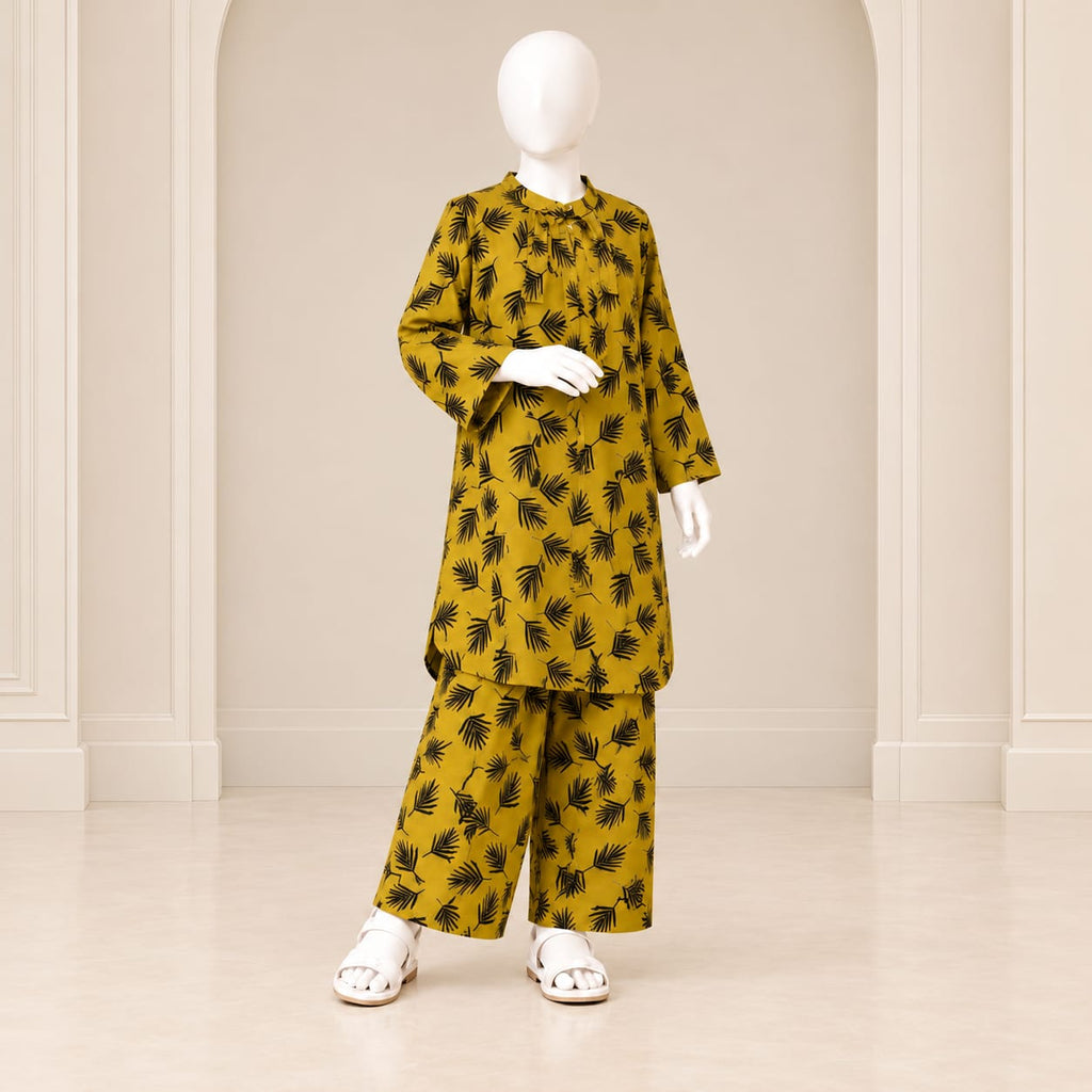 Girls’ mustard two-piece suit with black leaf motifs across a mustard base, a long-sleeved top and matching trousers