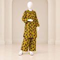 Girls’ mustard two-piece suit with black leaf motifs across a mustard base, a long-sleeved top and matching trousers