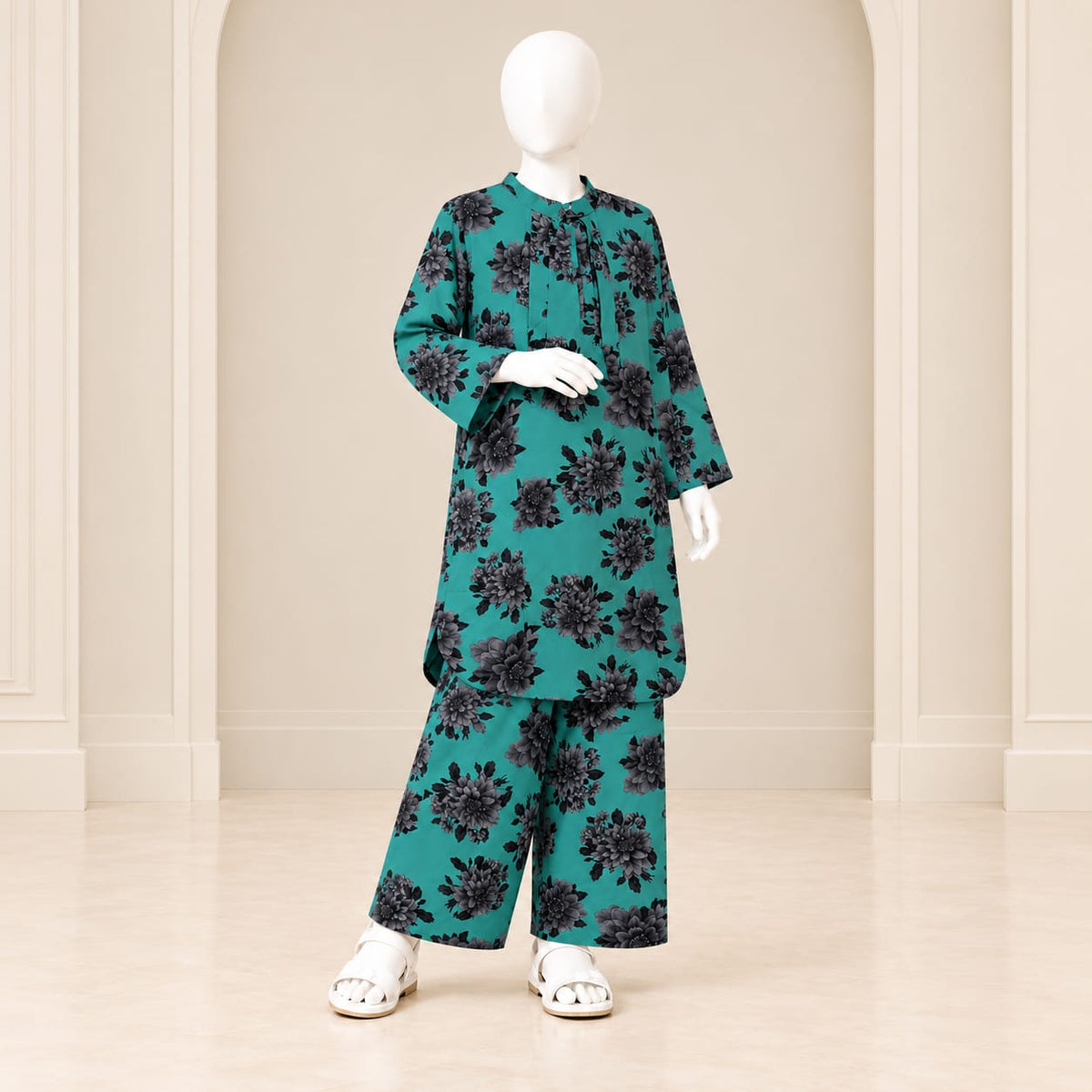 Girls’ ferozi two-piece suit with dark floral motifs across a turquoise-coloured base, a long-sleeved top and matching trousers