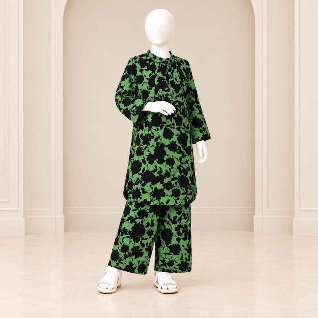 Girls’ green and black two-piece suit with black floral silhouettes on a green base, a long-sleeved top and matching trousers