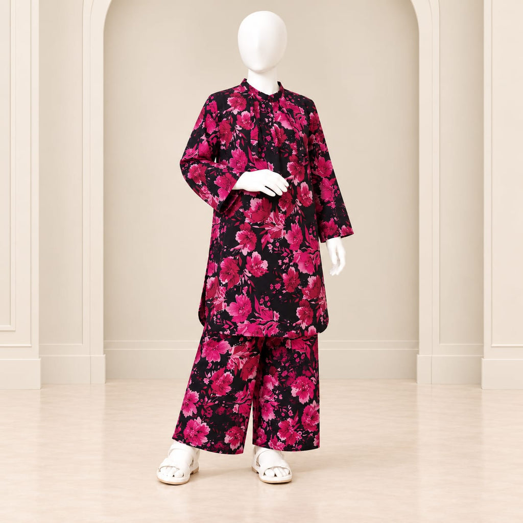Girls’ black and pink two-piece suit with a dense rose print in pink shades against black, a long-sleeved top and matching trousers