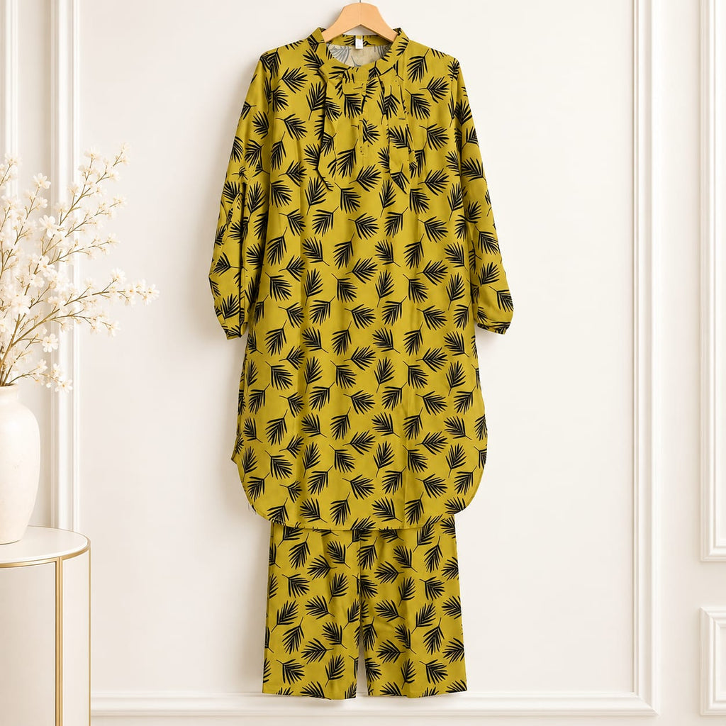 Mustard girls’ outfit on a hanger with dark leaf print and matching trousers