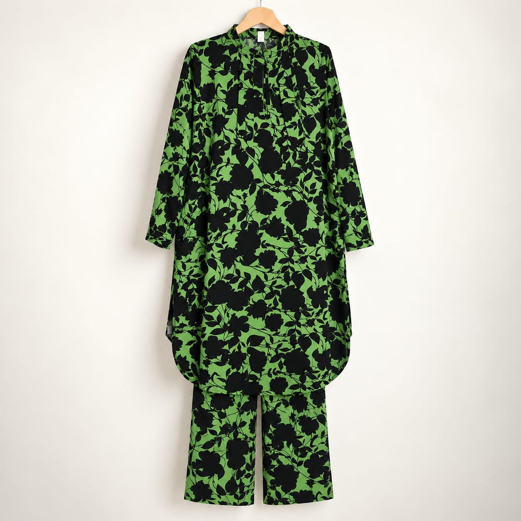 Green and black girls’ floral shirt with matching trousers displayed on a hanger